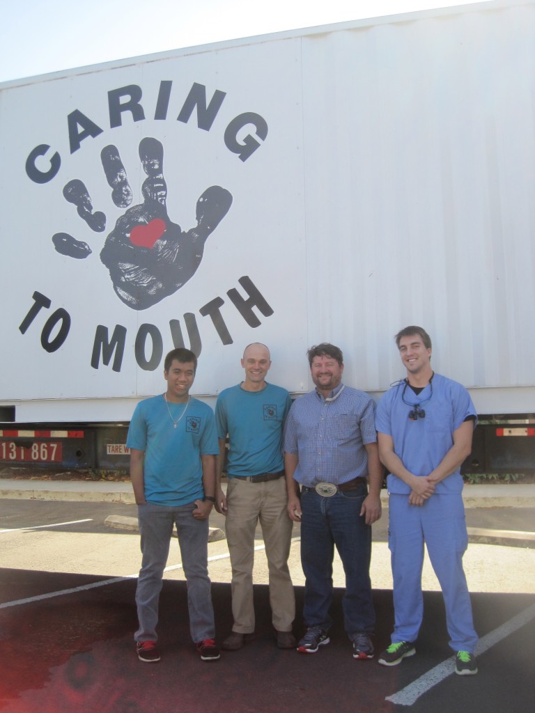 A shipping container purchased from the Port of Portland was modified into a mobile dental clinic for the local non-profit Caring Hand to Mouth.From left to right, volunteer Jesse Fox, Executive Director Randy Meyer, Dr. Cedric Ross Hayden, and Dr. Jeff Casebier. Photo by Vanessa Salvia  
